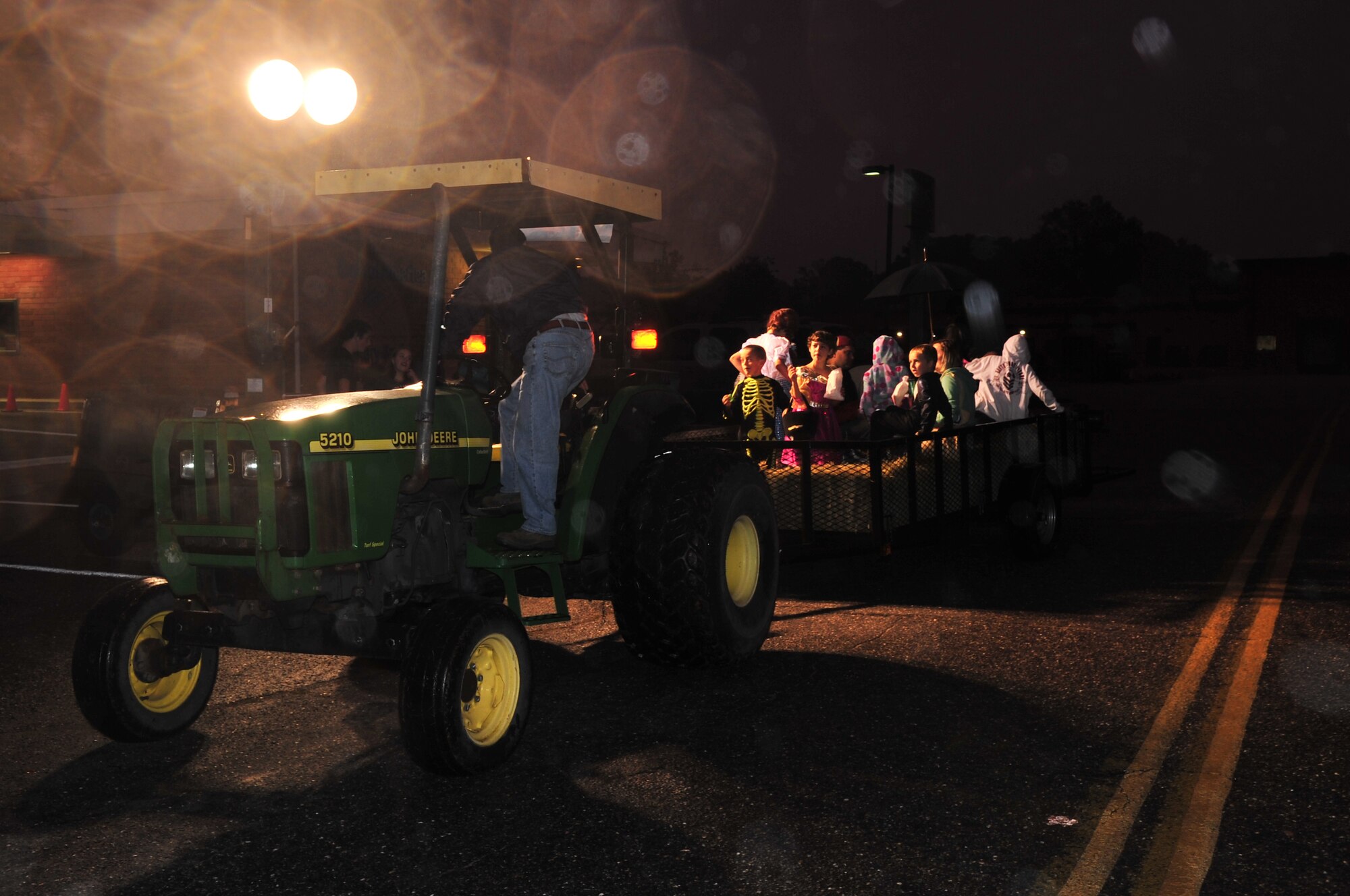 Airmen and their families enjoy a hay ride during the Halloween Block Party on Seymour Johnson Air Force Base, N.C., Oct. 30, 2009. The block party, coordinated by the community center, was an event for families to celebrate Halloween by wearing costumes and enjoying free games. (U.S. Air Force photo/Airman 1st Class Rae Perry)