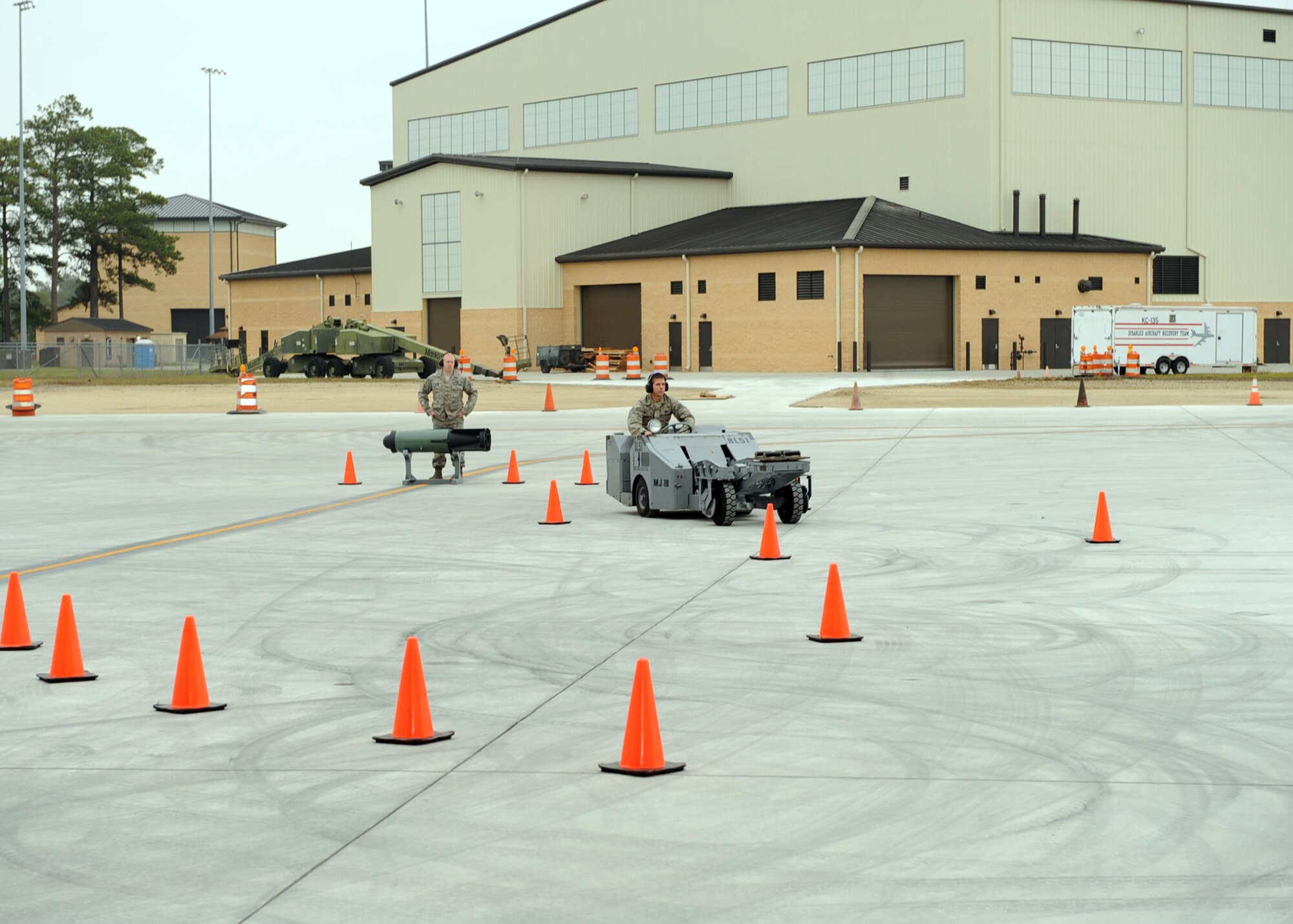 Senior Airman Cody Jurgensmeyer, 334th Aircraft Maintenance Unit weapons loader, drives a bomb lift truck through an obstacle course during the jammer competition on Seymour Johnson Air Force Base, N.C., Oct. 30, 2009. A jammer is a bomb lift truck used to transfer bombs and missiles from storage to the aircraft. (U.S. Air Force photo/Senior Airman Ciara Wymbs) 