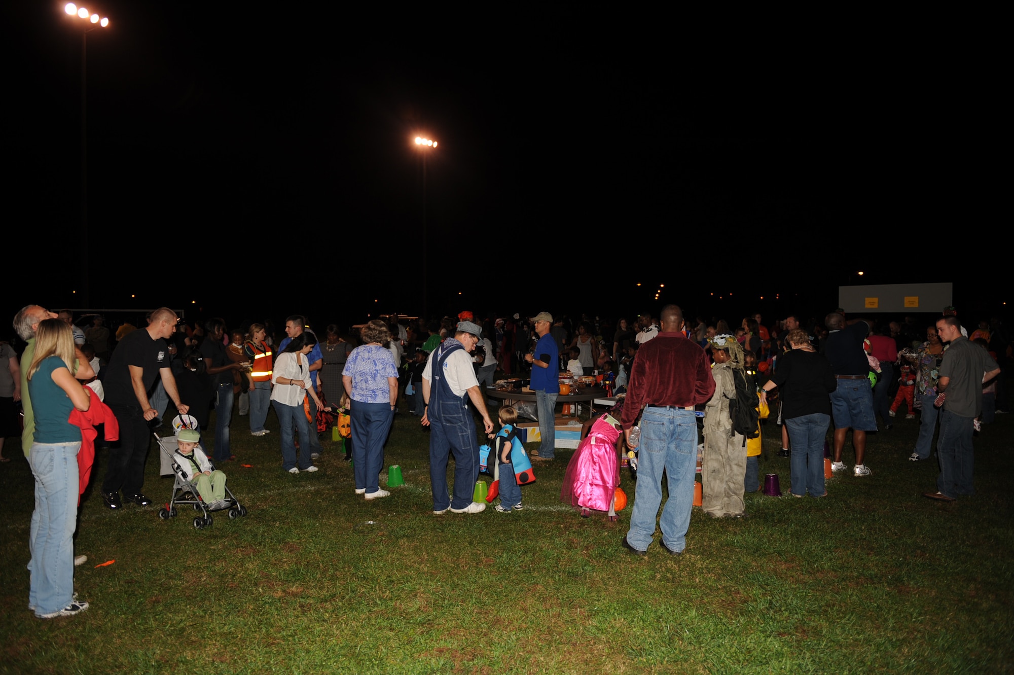 Military members and their dependents participate in a cake walk at the base Bhapel Harvest Festival on Seymour Johnson Air Force Base, N.C., Oct. 31, 2009. The cake walk is similar to musical chairs; only when the music stops whoever is standing in front of the cone with the number called by the announcer wins a cake, pie or other baked sweet.  (U.S. Air Force photo/Senior Airman Ciara Wymbs)

