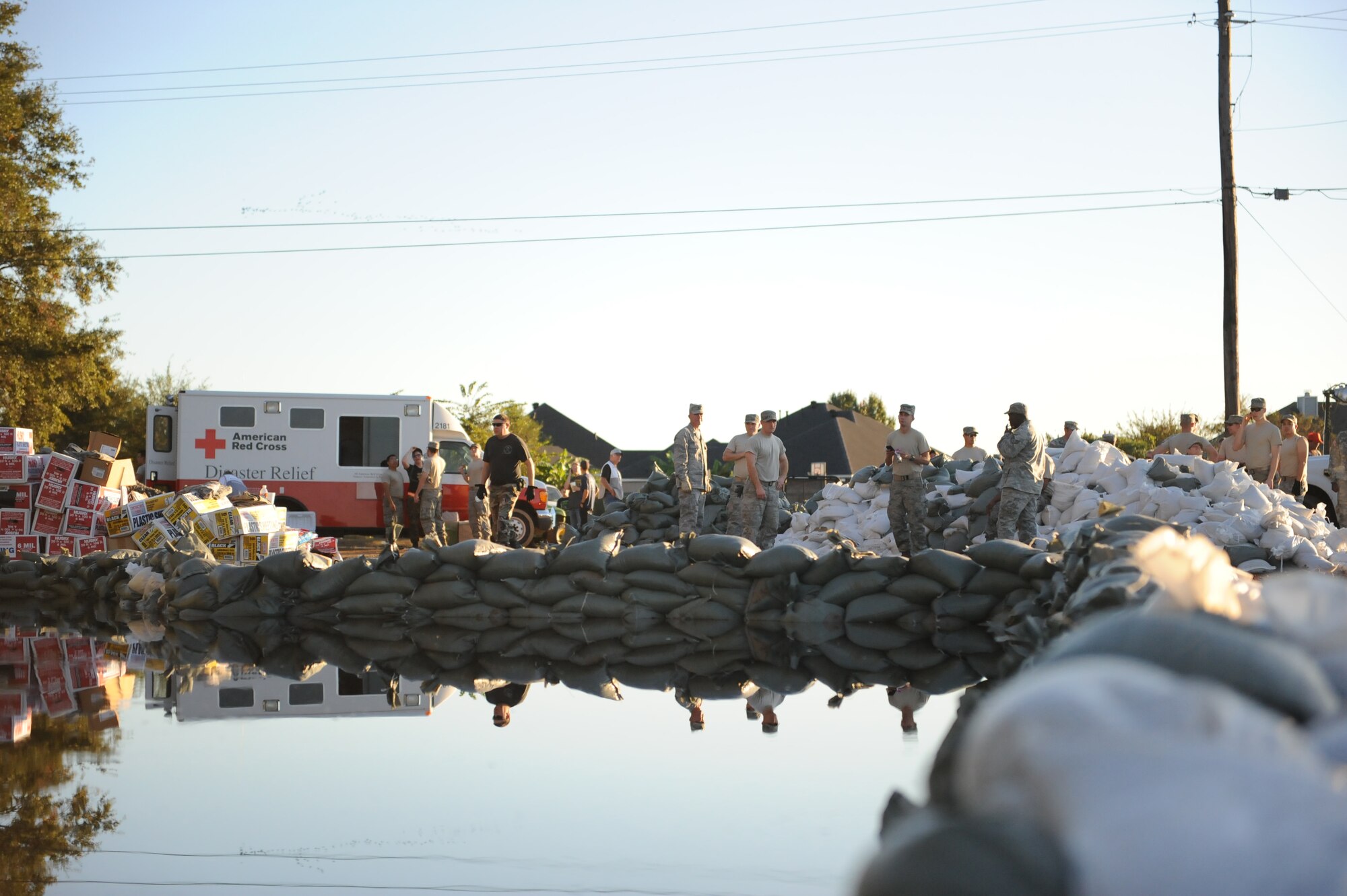 Airmen from Barksdale Air Force Base place sandbags on a levee to hold back floodwaters in Bossier City, La. The Airmen, at the request of state and local officials, have been working nonstop since early Saturday morning to reinforce the levee containing Red Chute Bayou. More than 400 Airmen have assisted with filling and hauling sandbags in a massive effort under immediate response authority. (U.S. Air Force photo by Maj. Carie Parker) 