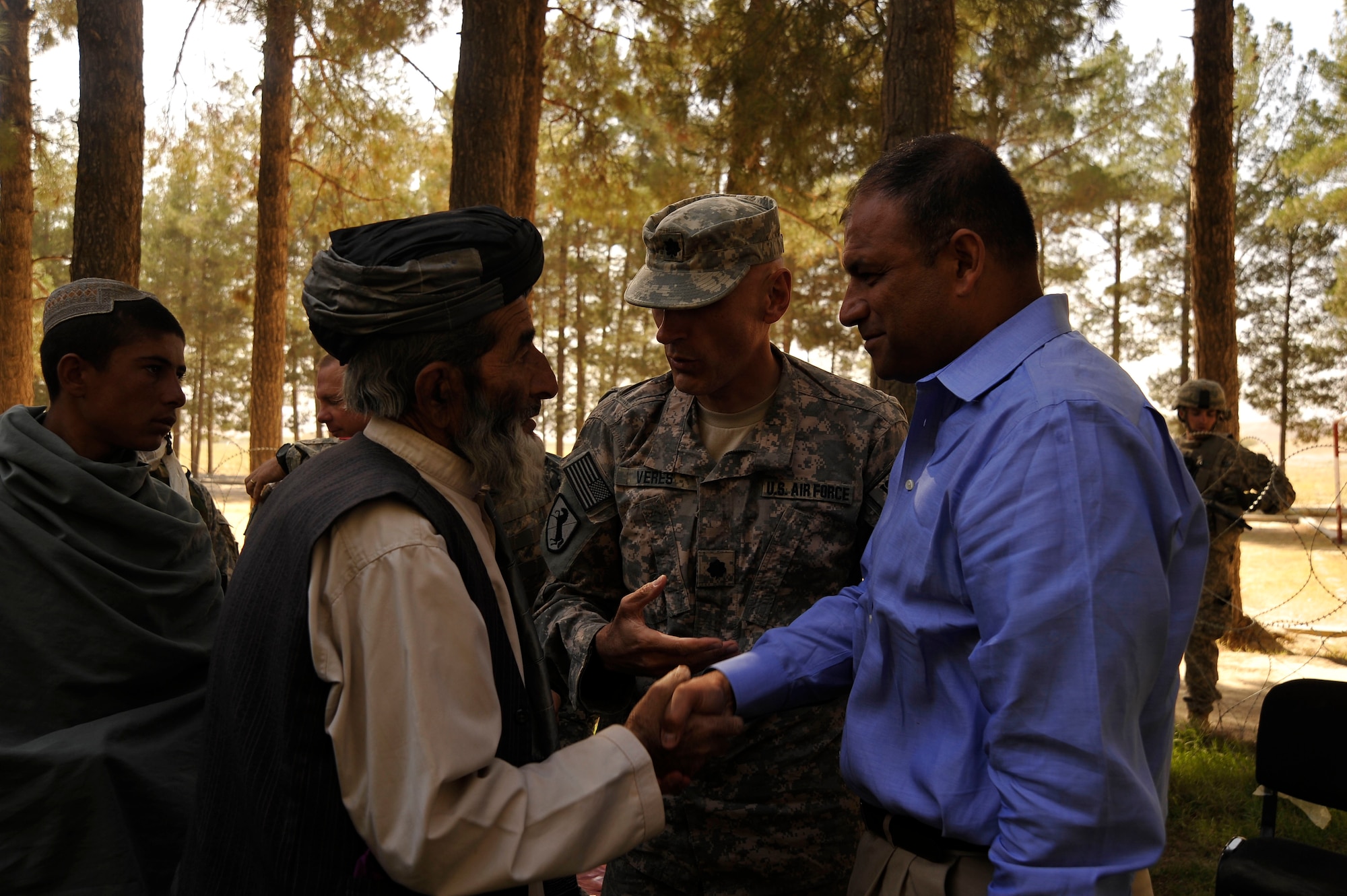 U.S. Air Force Lt. Col. Andy Veres, Commander of Provincial Reconstruction Team Zabul, introduces Department of State representative Jesse Alvardo to locals after a speech by the governor here Oct. 23, 2009. The governor is encouraging residents to vote so they can improve their county. (U.S. Air Force photo/Staff Sgt. Angelita Lawrence)