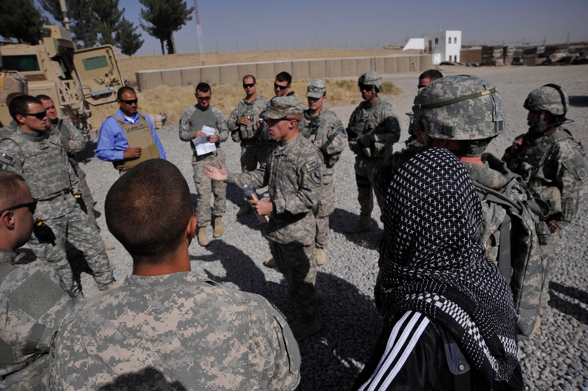 U.S. servicemembers from Provincial Reconstruction Team (PRT) Zabul, gather around U.S. Army 2nd Lt. Anthony Chesini, secuirty forces platoon leader, while he briefs the rules of engagement prior to a convoy to Shar-e-Safa  here Oct. 23, 2009. (U.S. Air Force photo/Staff Sgt. Angelita Lawrence)
