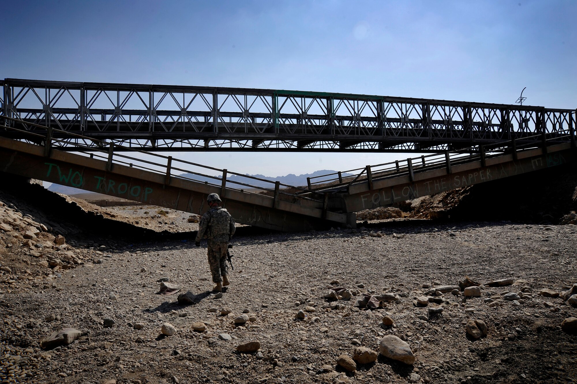 U.S. Air Force Capt. Rick Vermillion, a civil engineer assigned to Provincial Reconstruction Team Zabul, approaches a damaged bridge which he will inspect for improvised explosives devices or any traces of tampering Oct. 23, 2009.  The inspections provide safety to the people of Zabul as well as coalition forces while traveling. (U.S. Air Force photo/Staff Sgt. Angelita Lawrence)