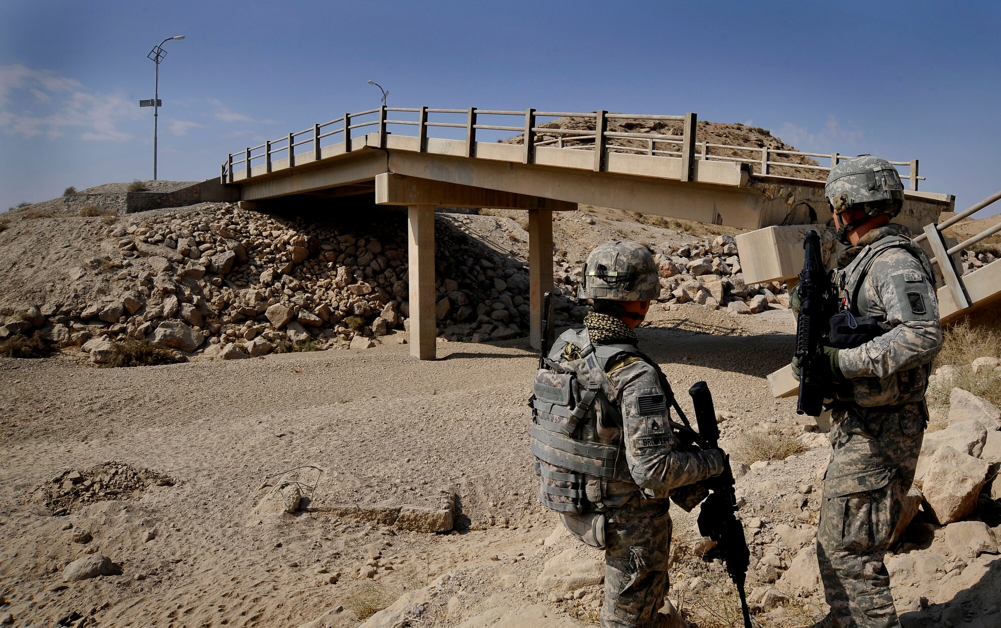 U.S. Army Sgt. William Brinkley and U.S. Air Force Capt. Rick Vermillion, a civil engineer assigned to the Provincial Reconstruction Team Zabul, speak about a bridge that has received damage from an improvised explosive devices here Oct. 23, 2009.  The inspections increase safety for the people of Zabul as well as coalition forces while traveling. (U.S. Air Force photo/Staff Sgt. Angelita Lawrence)
