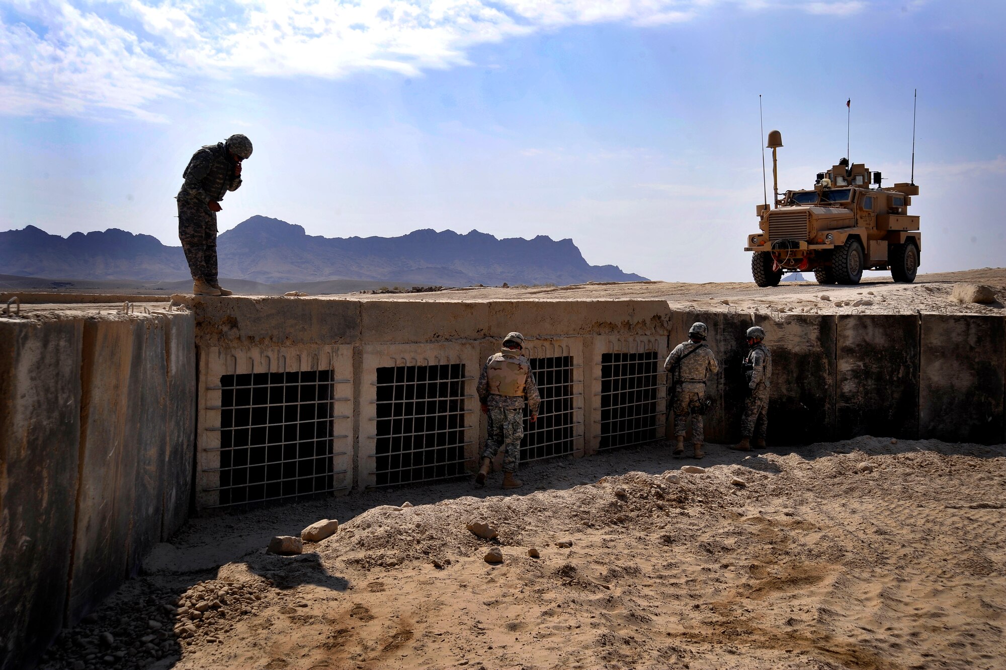 U.S. servicemembers from Provincial Reconstruction Team (PRT) Zabul inspects a bridge for improvised explosive devices, damages, or traces of tampering here Oct. 23, 2009.  The inspections increase safety for the people of Zabul as well as coalition forces while traveling. (U.S. Air Force photo/Staff Sgt. Angelita Lawrence)