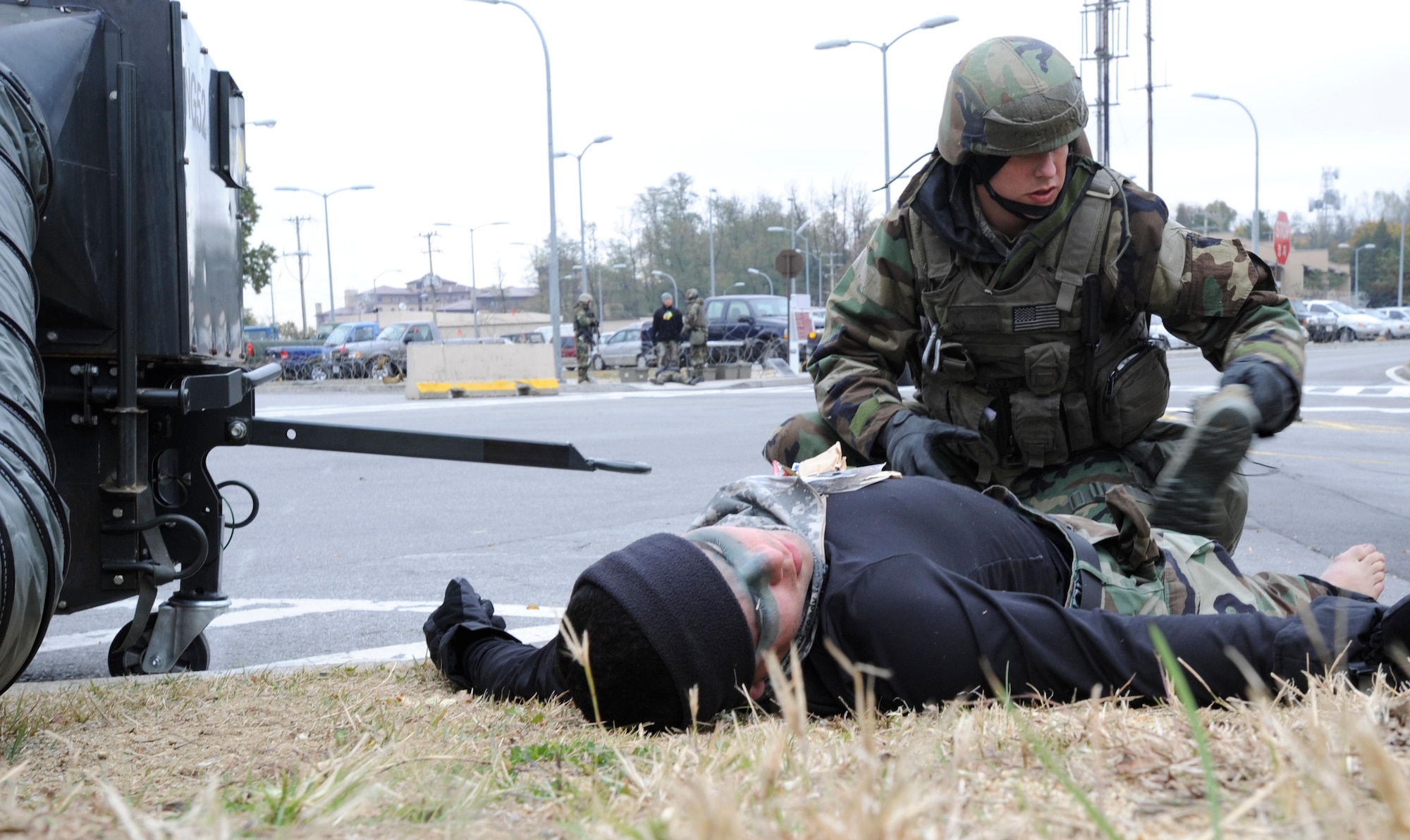 A 51st Security Forces Airman searches a simulated dead body outside of the 51st Fighter Wing headquarters building during operational readiness exercise Beverly Midnight 09-02 at Osan Air Base, Republic of Korea, Nov. 3. (U.S. Air Force photo by Senior Airman Stephenie Wade)
