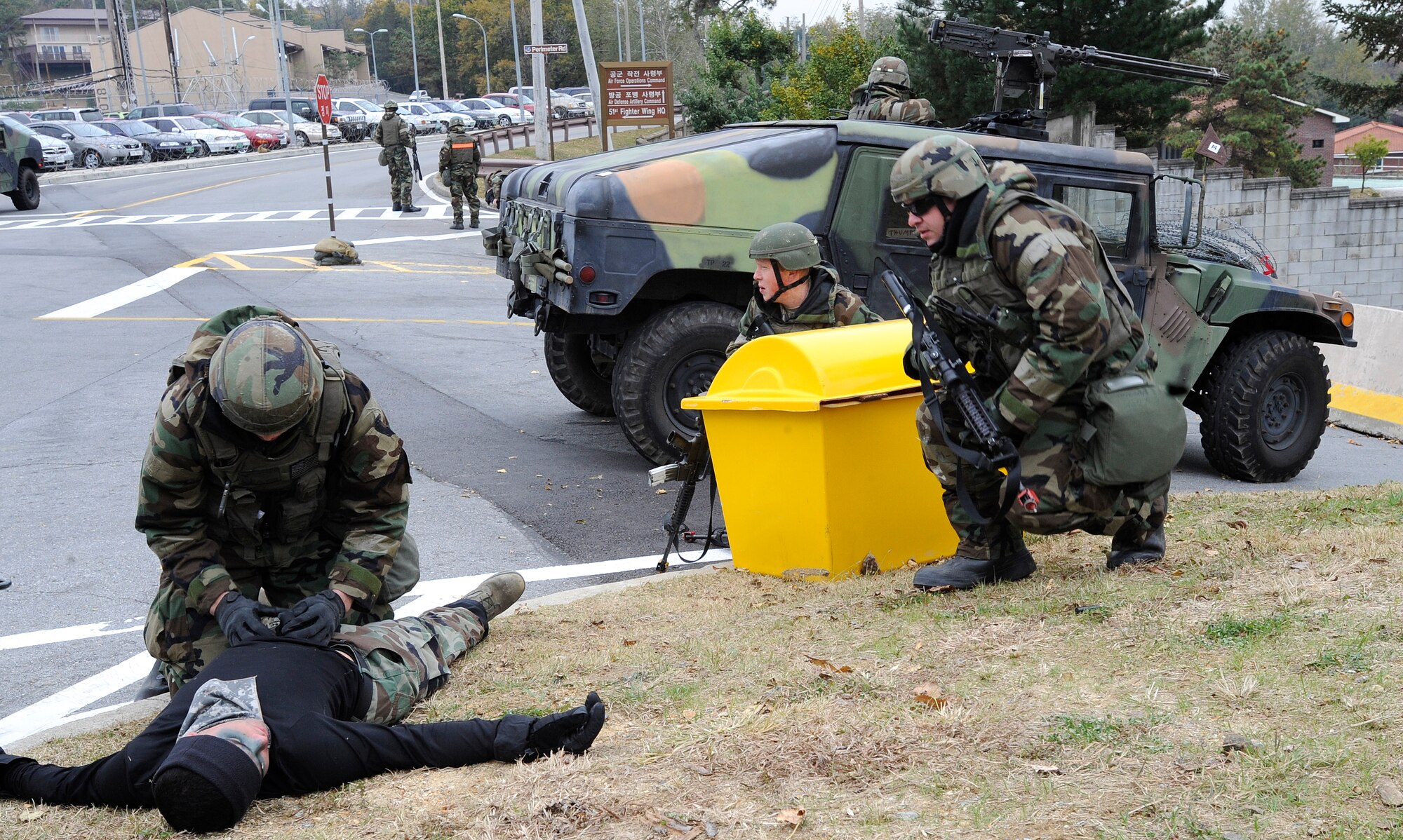 A 51st Security Forces Airman searches a simulated dead body outside of the 51st Fighter Wing headquarters building during operational readiness exercise Beverly Midnight 09-02 at Osan Air Base, Republic of Korea, Nov. 3. (U.S. Air Force photo by Senior Airman Stephenie Wade)
