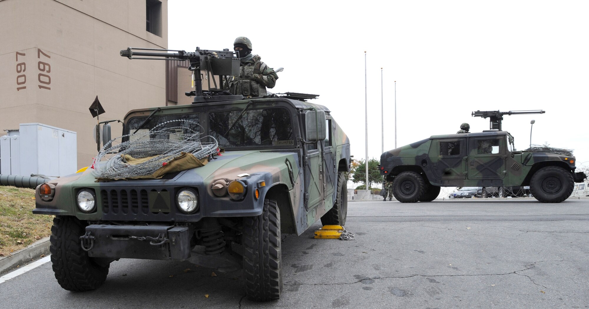 51st Security Forces Airmen guard the base and fight off opposing forces near the 51st Fighter Wing headquarters building during operational readiness exercise Beverly Midnight 09-02 at Osan Air Base, Republic of Korea, Nov. 3. (U.S. Air Force photo by Senior Airman Stephenie Wade)
