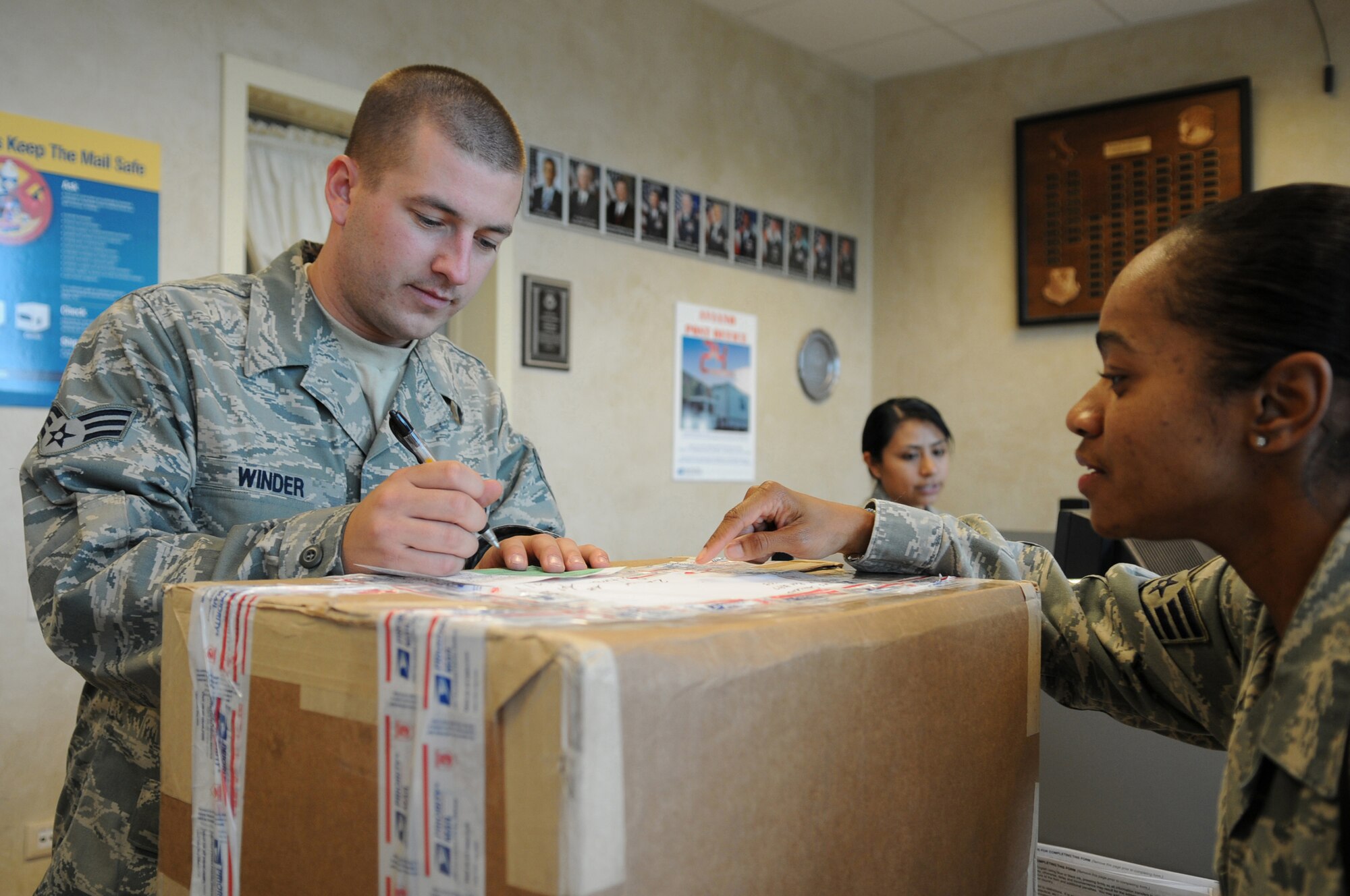 Senior Airman Jeffery Winder, 31st Communications Squadron, postal
specialist, checks a customs form for a package being sent, Aviano Air Base,
Italy. The Post Office is in charge of all in-coming and out-going mail for
military personnel and their families stationed at Aviano. (U.S. Air Force
photo/Senior Airman Nadine Y. Barclay)
