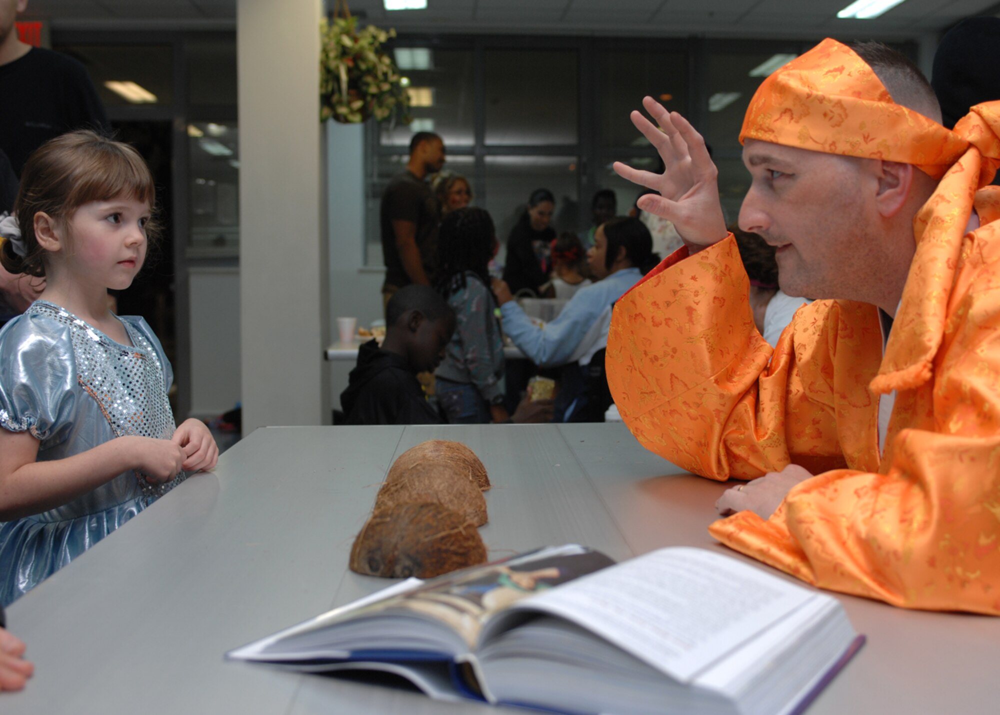 Master Sgt. Brian Nuss, 39th Operations Squadron, tells a story from the bible to Kayla Schill, daughter of Tech. Sgt. Adam Schill, 39th OS, during the chapel harvest festival Saturday, Oct. 31, 2009, at Incirlik Air Base, Turkey. The theme of the evening was ‘Walking through the Bible’ and was the Chapel’s alternative to secular Halloween celebrations. More than 300 people participated in arts and crafts and activities based on Bible stories. (U.S. Air Force photo/Staff Sgt. Lauren Padden) 