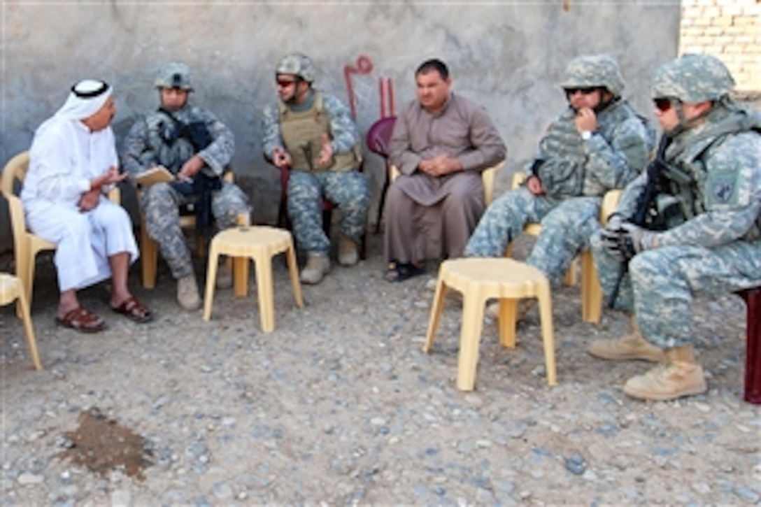 U.S. Army soldiers and members of a Civil Affairs Battalion meet with a village leader to organize several community projects in the area, including a school supply drop in Manarah village near Mosul, Iraq, Oct. 24, 2009. The soldiers are assigned to the 1st Cavalry Division's Alpha Battery, 2nd Battalion, 82nd Field Artillery Regiment, 3rd Brigade Combat Team.
