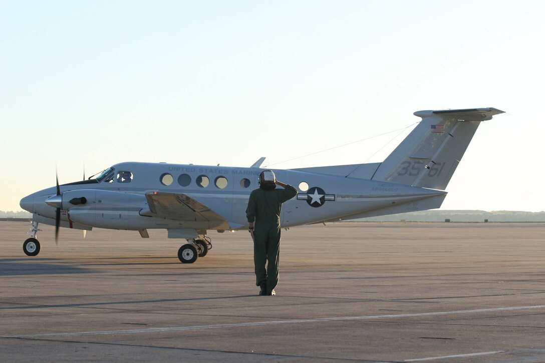 Lance Cpl. Christopher T. Brutzman, a traffic management specialist with the Visiting Aircraft Line, Headquarters and Headquarters Squadron Marine Corps Air Station Miramar, Marine Corps Installations West, assists pilots taxiing UC-12F “King Air” on the flight line here, Nov. 3. Fixed Wing Marine Transport Detachment here has the responsibility of transporting VIP and personnel throughout the region and other parts of the United States.
