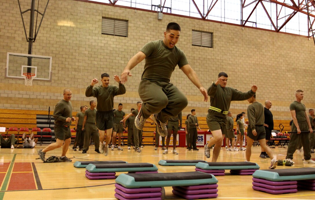 Sgt. Chris Fisher, weapons technician, 1st Battalion, 1st Marine Regiment, 1st Marine Division, leaps over an aerobic step during a Marine Corps Community Services circuit course in recognition of the 234th Marine Corps birthday at the base’s Paige Fieldhouse, Nov. 4.