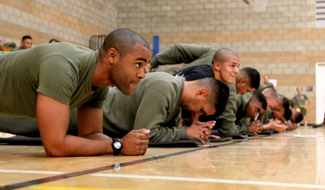 Sgt. Francisco Cortez, instructor, weapons field training battalion, Camp Pendleton, concentrates during a core stengthening excersise at a special Semper Fit circuit course. The course was held in recognition of the 234th Marine Corps birthday at the base’s Paige Fieldhouse, Nov. 4.