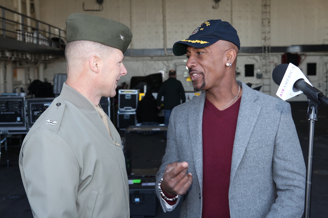 Special Purpose Marine Air Ground Task Force 26 commanding officer, Col. Mark J. Desens, speaks with Montel Williams, host of the radio broadcast Montel Across America,  which aired live from the flight deck of USS New York Nov. 4, 2009. Aboard the ship are Marines from several units that merged to form SPMAGTF-26. The ship, which has 7 1/2 tons of steel salvaged from the World Trade Center forged into its hull, is scheduled to be commissioned Nov. 7.