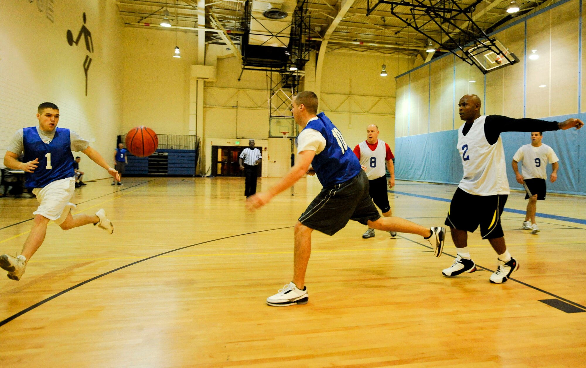 ELMENDORF AIR FORCE BASE, Alaska – 3rd Equipment Maintenance Squadron teammates Klay White, left, and Craig Townsend go after the basketball Nov. 3 at the Fitness Center during a basketball game. The 3rd EMS faced off against the U.S. Coast Guard, in what was a back and forth game with the CG coming out on top 43-40. (U.S. Air Force photo/Airman 1st Class Christopher Gross)