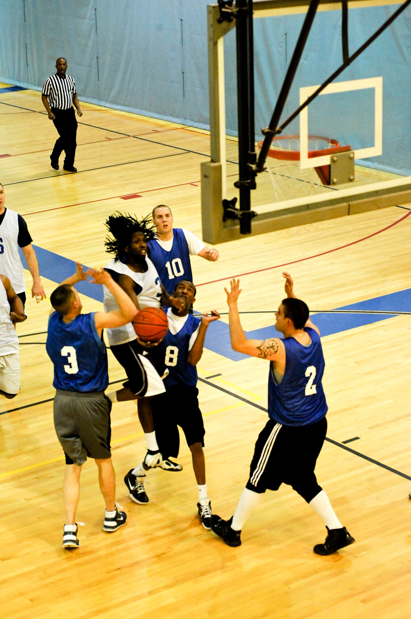 ELMENDORF AIR FORCE BASE, Alaska ? Hancock attempts a layup between three 3rd Equipment Maintenance Squadron defenders during a basketball game Nov. 3 at the Fitness Center. Hancock scored seven of his teams?, U.S. Coast Guard, total 43 points. The teams kept the game close right up to the final seconds. The CG shot the game winning shot as time expired to win 43-40.  (U.S. Air Force photo/Airman 1st Class Christopher Gross)