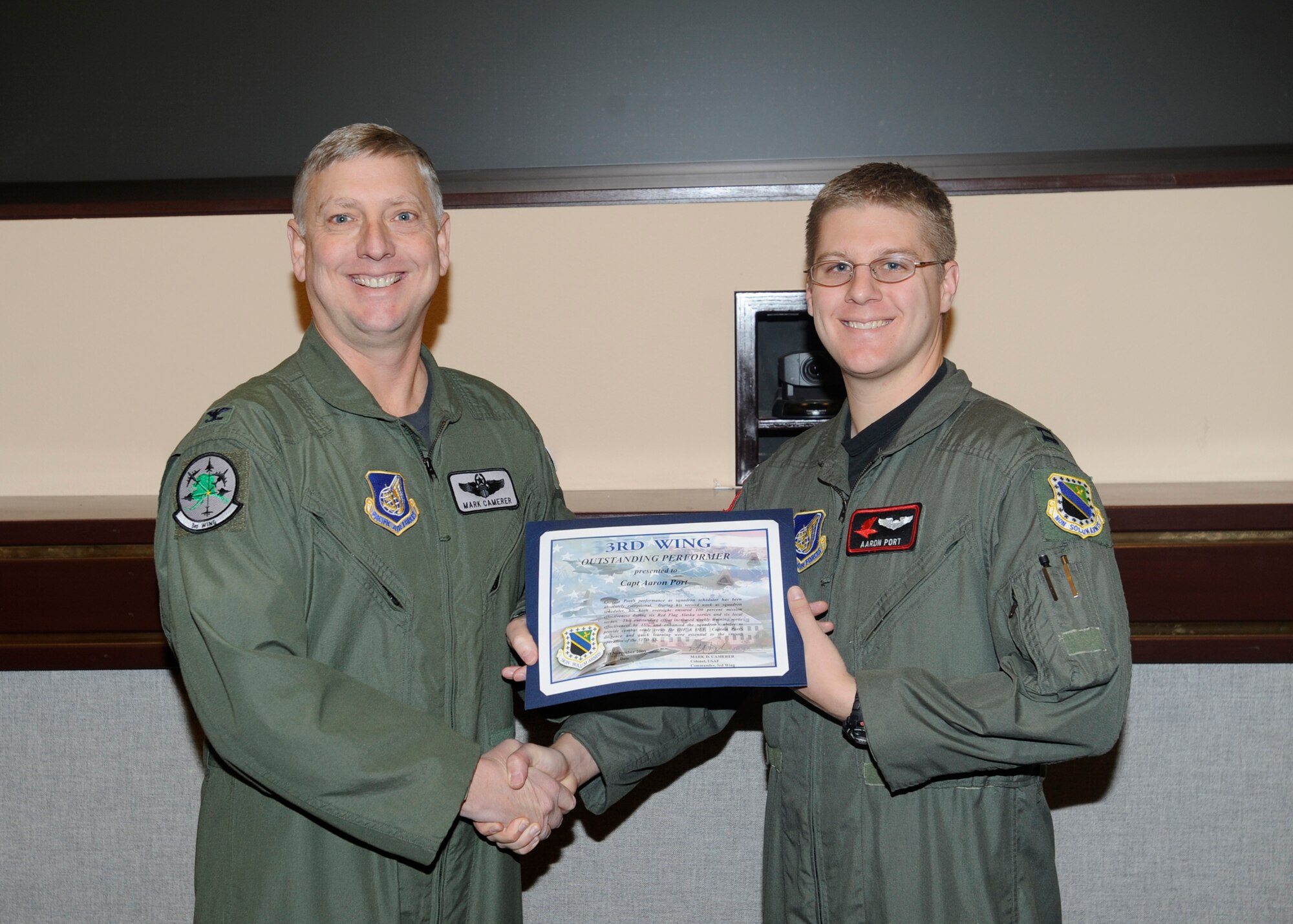 ELMENDORF AIR FORCE BASE, Alaska-- Capt. Aaron Port, 517th Airlift Squadron, receives a Bronze Star certificate from Col. Mark Camerer, 3rd Wing  vice commander, Nov. 3, 2009. (U.S. Air Force photo/ Senior Airman Matt Coleman-Foster)