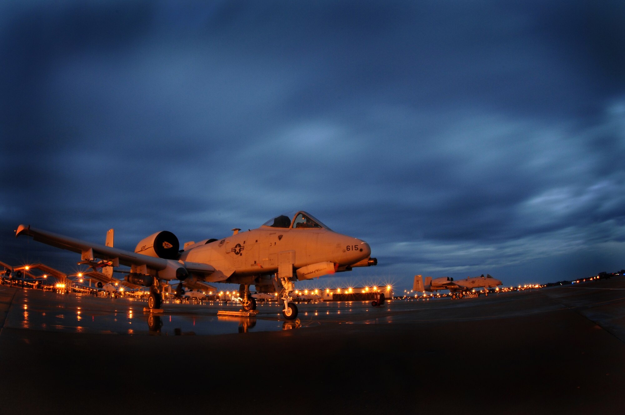 WHITEMAN AIR FORCE BASE, Mo. ? Clouds race over the 442nd Fighter Wing's A-10 Thunderbolt II?s during the early hours of the morning Oct. 29. The 442nd FW maintains a vast fleet of 27 A-10's. The A-10 is designed to provide close air support for ground forces by attacking tanks, armored vehicles, and other ground targets with a limited air interdiction capability. (U.S. Air Force photo/Senior Airman Kenny Holston)(Released)  