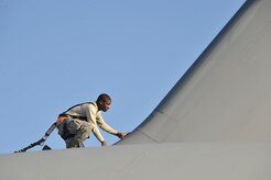 Airman 1st Class Alexander McCall performs an inspection looking for discrepancies on top of a C-17 on the flightline at Charleston Air Force Base, S.C. Nov. 4. In addition to scheduled and non-scheduled maintenance, inspections are a requirement for all C-17 aircraft to ensure operational integrity during flight. Airman McCall is a crew chief with the 315th Aircraft Maintenance Squadron. (U.S. Air Force photo/James Bowman)