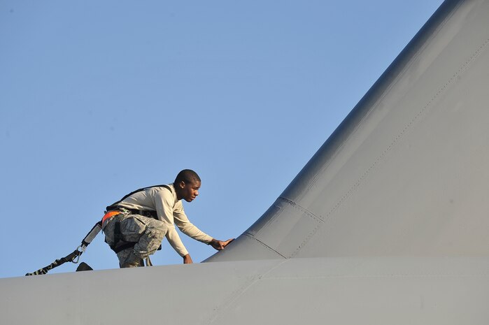 Airman 1st Class Alexander McCall performs an inspection looking for discrepancies on top of a C-17 on the flightline here Nov. 4. In addition to scheduled and non-scheduled maintenance, inspections are a requirement for all C-17 aircraft to ensure operational integrity during flight. Airman McCall is a crew chief with the 315th Aircraft Maintenance Squadron. (U.S. Air Force photo/James Bowman)