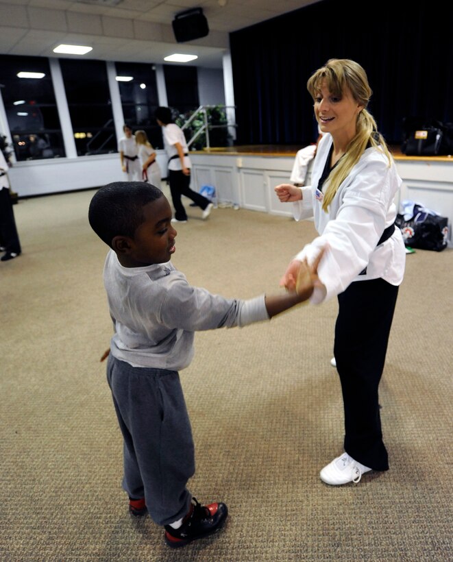LANGLEY AIR FORCE BASE, Va. - Tricia Tinnon, International Combat Hapikdo Federation instructor and second-degree black belt, teaches Kalonji Blount, 7, grandson of Carol Shaw, Air Combat Command Safety, self-defense tactics Nov. 3. The Family Self-Defense Class, taught by trained black belts from the International Combat Hapikdo Federation, is one of many events held during Military Family Week, Nov. 1-7. (U.S. Air Force photo/Senior Airman Dana Hill)
