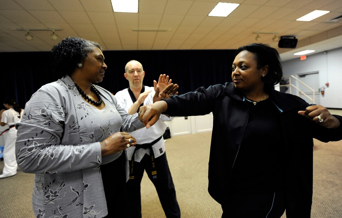 LANGLEY AIR FORCE BASE, Va. - Carol Shaw, Air Combat Command, and Cynthia Bush, 1st Force Support Squadron, practice basic self-defense tactics during the Family Self-Defense Class Nov. 3. Taught by trained black belts from the International Combat Hapikdo Federation, the class is one of many events held during Military Family Week, Nov. 1-7. (U.S. Air Force photo/Senior Airman Dana Hill)