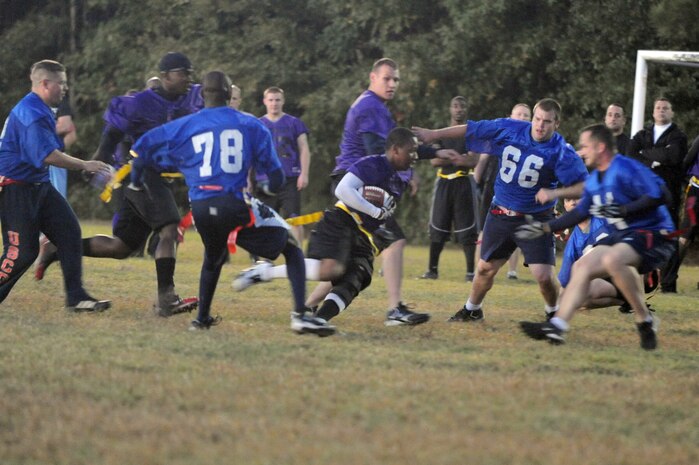 Members of the 437th Security Forces Squadron and the Coast Guard intramural flag football teams battle it out during a game here Nov. 3. A total of 13 teams compete in the intramural league, with 10 representing various Charleston AFB squadrons. (U.S. Air Force photo/Staff Sgt. Marie Brown)