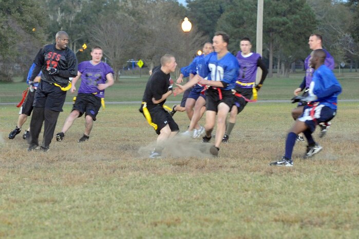 Members of the 437th Security Forces Squadron flag football team try to get past Coast Guard players during an intramural flag football game here Nov. 3. The 437 SFS defeated the Coast Guard 20-6. (U.S. Air Force photo/Staff Sgt. Marie Brown)