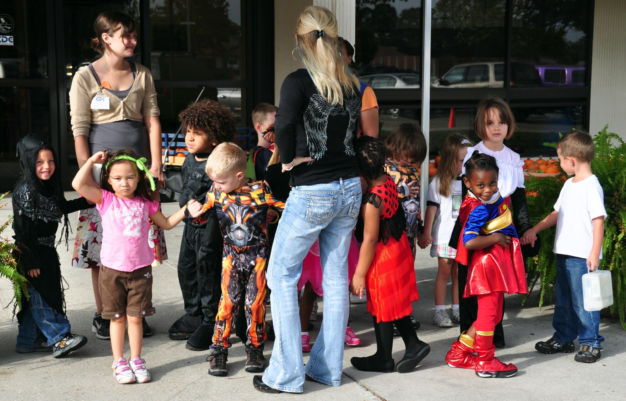 Three and four-year-olds from the Child Devolpment Center march to the library in their costumes to celebrate Halloween. (U.S. Air Force photo by Airman 1st Class Rachelle Elsea)