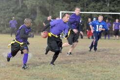 Ray Livingston, left, protects Matt Cancallare, right, as he runs the football down the field during an intramural flag football game between the 437th Security Forces Squadron and the Coast Guard here Nov. 3. The flag football regular season began Oct. 27 and will last until Jan. 6. Livingston and Cancallare are both members of the 437 SFS. (U.S. Air Force photo/Staff Sgt. Marie Brown)