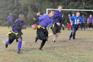Ray Livingston, left, protects Matt Cancallare, right, as he runs the football down the field during an intramural flag football game between the 437th Security Forces Squadron and the Coast Guard here Nov. 3. The flag football regular season began Oct. 27 and will last until Jan. 6. Livingston and Cancallare are both members of the 437 SFS. (U.S. Air Force photo/Staff Sgt. Marie Brown)
