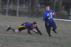 Joshua Cook removes the flag from a Coast Guard player in order to stop him from getting a first down during an intramural flag football game held here Nov. 3. The game was held between the 437th Security Forces Squadron and the Coast Guard. Cook is a member of the 437 SFS. (U.S. Air Force photo/Staff Sgt. Marie Brown)