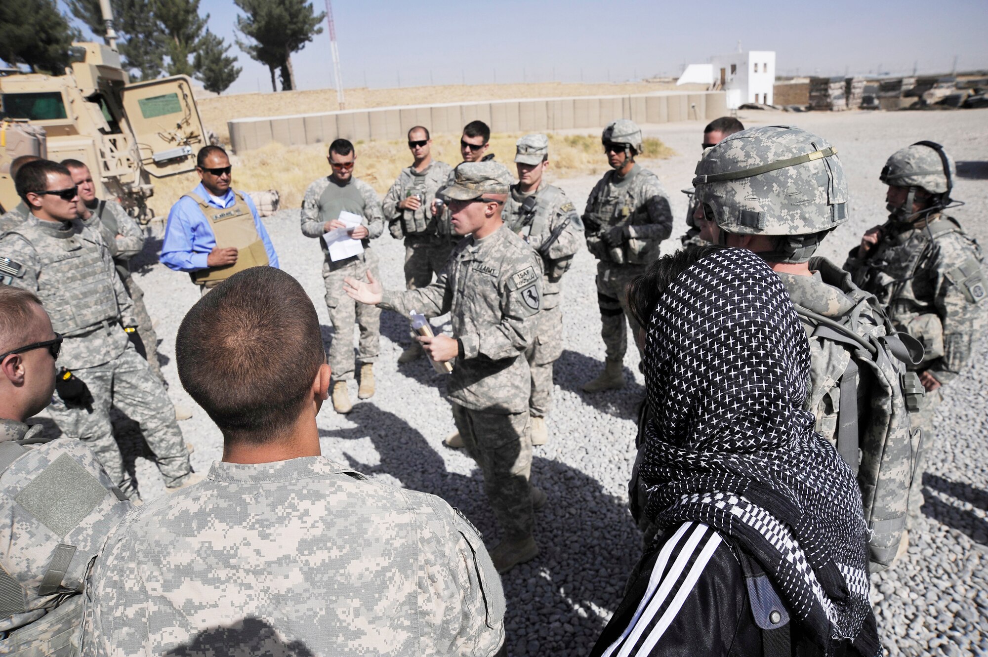U.S. servicemembers from Provincial Reconstruction Team (PRT) Zabul, gather around U.S. Army 2nd Lt. Anthony Chesini, secuirty forces platoon leader, while he briefs the rules of engagement prior to a convoy to Shar-e-Safa  here Oct. 23, 2009. (U.S. Air Force photo/Staff Sgt. Angelita Lawrence)