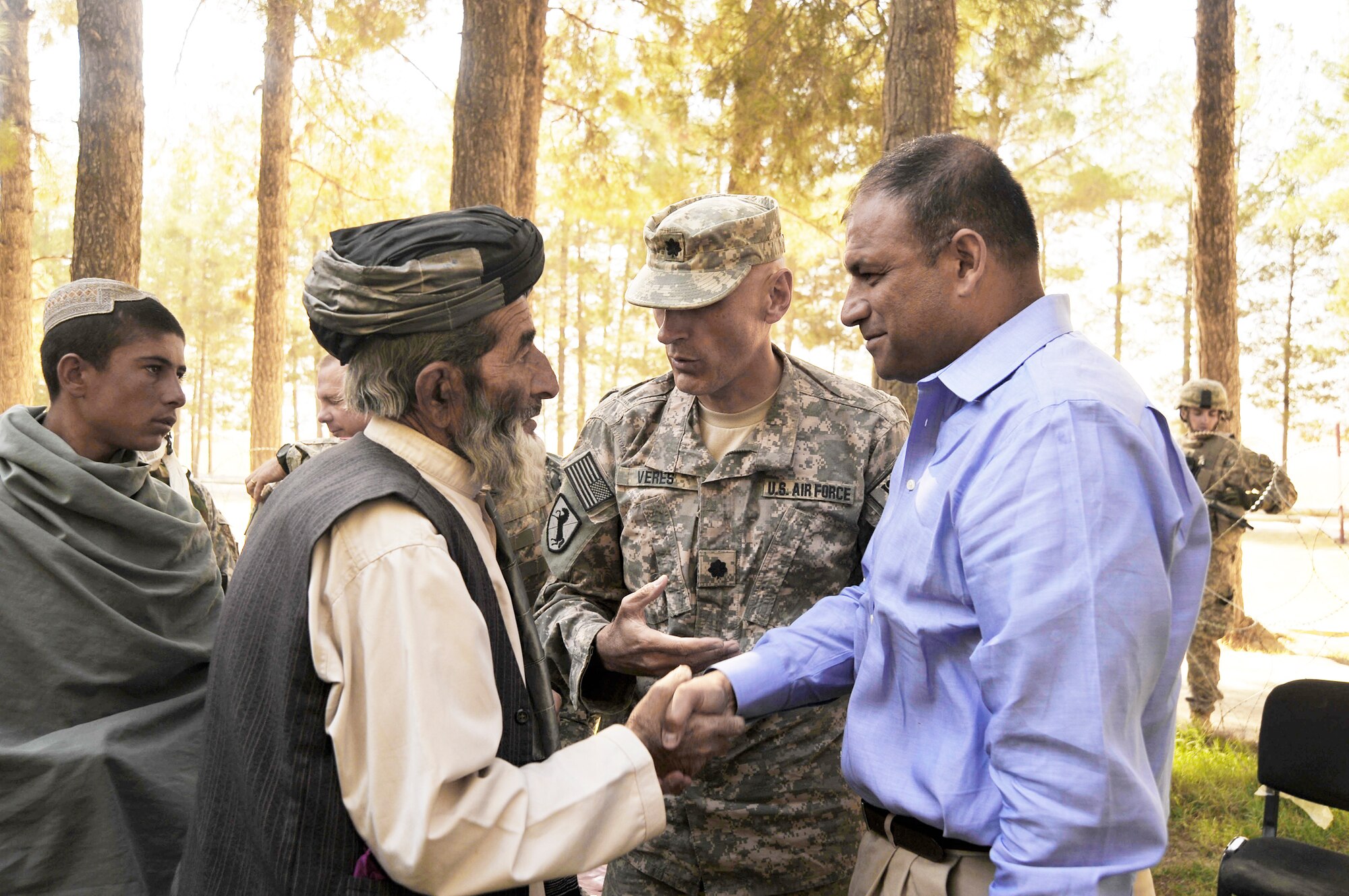 U.S. Air Force Lt. Col. Andy Veres, Commander of Provincial Reconstruction Team Zabul, introduces Department of State representative Jesse Alvardo to locals after a speech by the governor here Oct. 23, 2009. The governor is encouraging residents to vote so they can improve their county. (U.S. Air Force photo/Staff Sgt. Angelita Lawrence)