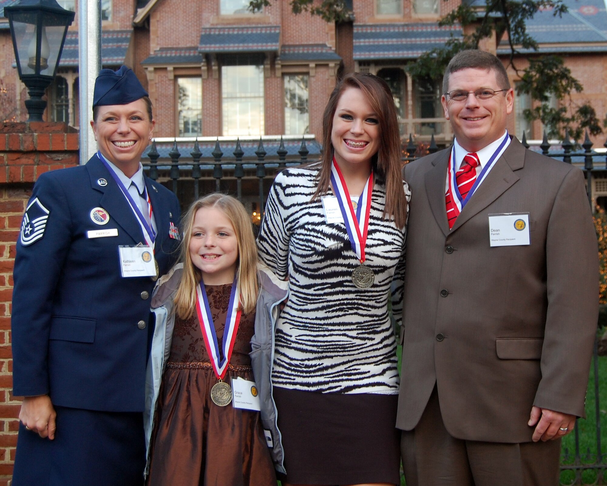 Master Sgts. Kathleen and Dean Parrish, 4th Force Support Squadron and 4th Fighter Wing Plans and Evaluations respectively, and their daughters, Grace, age 10, and Lauren, age 15, receive the North Carolina Medallion Award for volunteerism at the North Carolina governor’s mansion, Nov. 3, 2009. North Carolina Governor Bev Perdue presented the state volunteerism award to each family member for their service. The Parrish family donated countless hours towards training Special Olympics athletes in track and field. They also mentored young adults in the Smart Choices for Youth program in Wayne County. (Courtesy Photo)