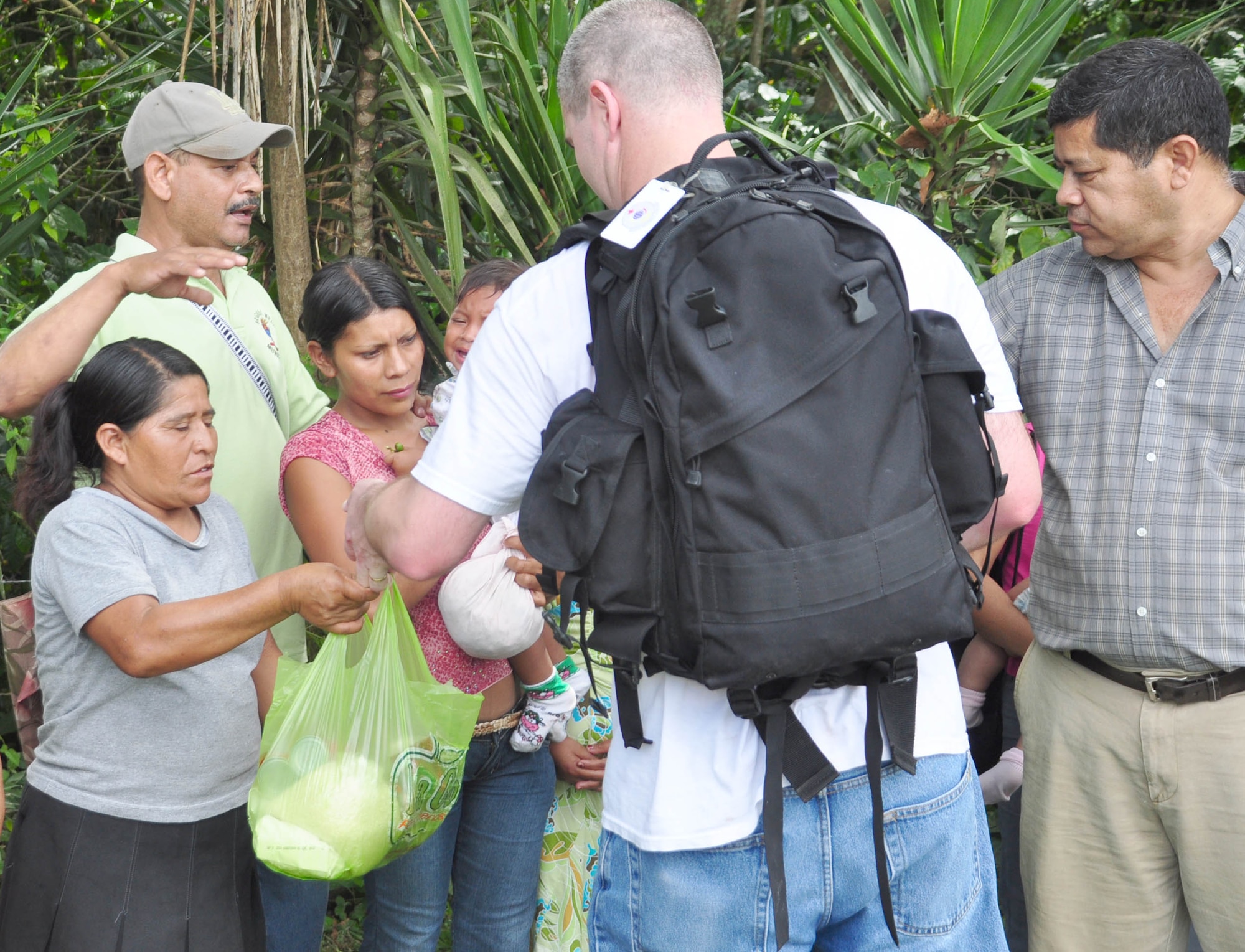 SOTO CANO AIR BASE, Honduras – Air Force Maj. Rick Schott, medical element anesthesiologist, hands a bag filled with food to some villagers of El Ciruelo, a remote mountain village near Comayagua, Honduras, Oct 31 for a monthly chapel hike. Eighty-one volunteers from Joint Task Force-Bravo hiked more than five miles up and down a rocky, mountain road to deliver food to the remote village. The volunteers carried a total of 122 bags of food, equaling 2,684 pounds. Each bag of food was intended to go to one of the families of this poor mountain village, and included vegetable oil, ketchup, pasta, a couple cans of sardines and bags of sugar, rice, flour and beans (U.S. Air Force photo/Staff Sgt. Chad Thompson).