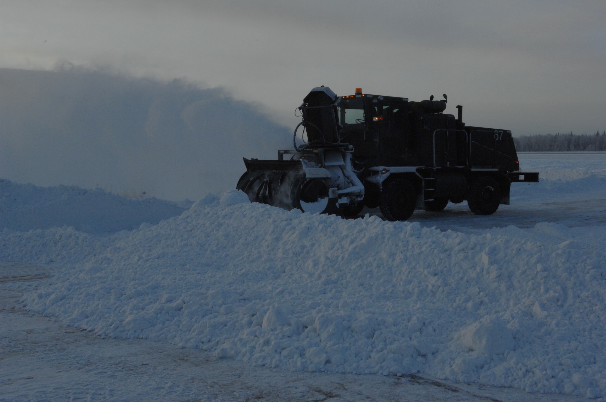 A 354th Civil Engineer Squadron Snow Barn snow blower clears snow from the flightline Oct. 30, 2009, Eielson Air Force Base, Alaska. The snow barn is responsible for clearing Eielson's runways, roads, and parking lots. (U.S. Air Force photo/Airman 1st Class Rachelle Coleman)