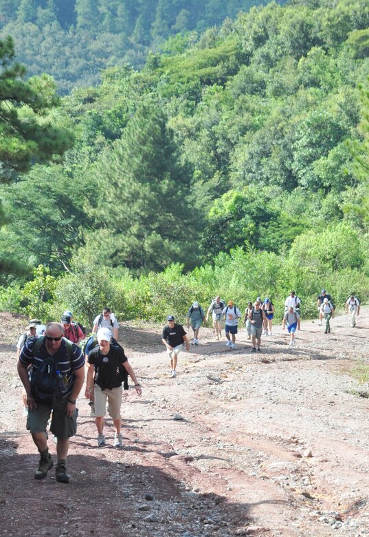 SOTO CANO AIR BASE, Honduras – Volunteers climb a steep grade of mountain road near Comayagua, Honduras Oct. 31 for a monthly chapel hike. Eighty-one volunteers from Joint Task Force-Bravo hiked more than five miles up and down a rocky, mountain road just outside of Comayagua, Honduras to deliver food to a remote village. The volunteers carried a total of 122 bags of food, equaling 2,684 pounds. Each bag of food was intended to go to one of the families of this poor mountain village, and included vegetable oil, ketchup, pasta, a couple cans of sardines and bags of sugar, rice, flour and beans (U.S. Air Force photo/Staff Sgt. Chad Thompson).
