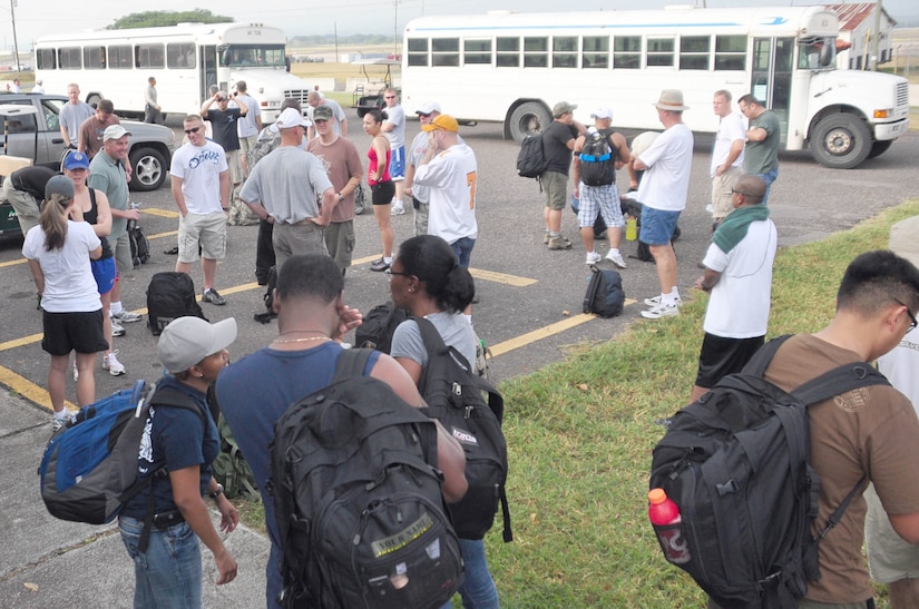 SOTO CANO AIR BASE, Honduras – Volunteers gather in the base chapel parking lot Oct. 31 for a monthly chapel hike. Eighty-one volunteers from Joint Task Force-Bravo hiked more than five miles up and down a rocky, mountain road just outside of Comayagua, Honduras to deliver food to a remote village. The volunteers carried a total of 122 bags of food, equaling 2,684 pounds. Each bag of food was intended to go to one of the families of this poor mountain village, and included vegetable oil, ketchup, pasta, a couple cans of sardines and bags of sugar, rice, flour and beans (U.S. Air Force photo/Staff Sgt. Chad Thompson).