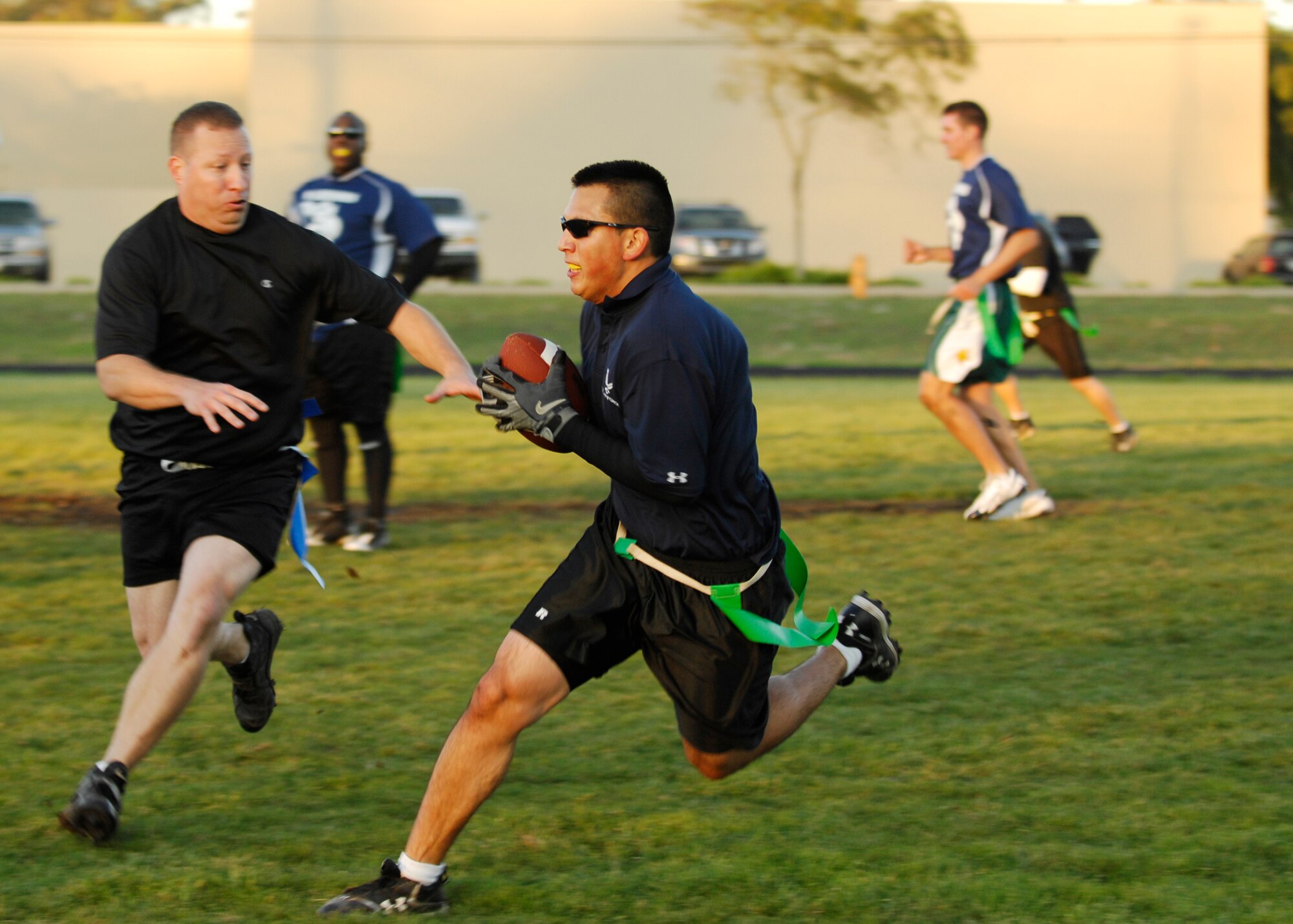 VANDENBERG AIR FORCE BASE, Calif. -- Hoping to elude his opponents, Alex Mancero, of the 392nd Training Squadron, tries to sneak past without having his flags pulled off here Thursday, Oct. 29, 2009. The 392nd TRS won the game, 8-0, against the 30th Launch Group. (U.S. Air Force photo/Airman 1st Class Heather R. Shaw)