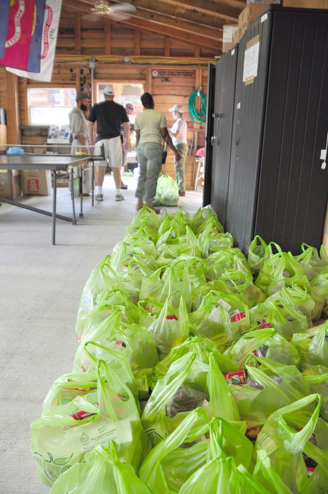 SOTO CANO AIR BASE, Honduras – More than 100 bags filled with vegetable oil, ketchup, pasta, a couple cans of sardines and bags of sugar, rice, flour and beans lay waiting for volunteers Oct. 31 in the chapel's activity room, the Crossroads. Eighty-one volunteers from Joint Task Force-Bravo hiked more than five miles up and down a rocky, mountain road Oct. 31 just outside of Comayagua, Honduras to deliver food to a remote village. The volunteers carried a total of 122 bags of food, equaling 2,684 pounds. Each bag of food was intended to go to one of the families of this poor mountain village. (U.S. Air Force photo/Staff Sgt. Chad Thompson).