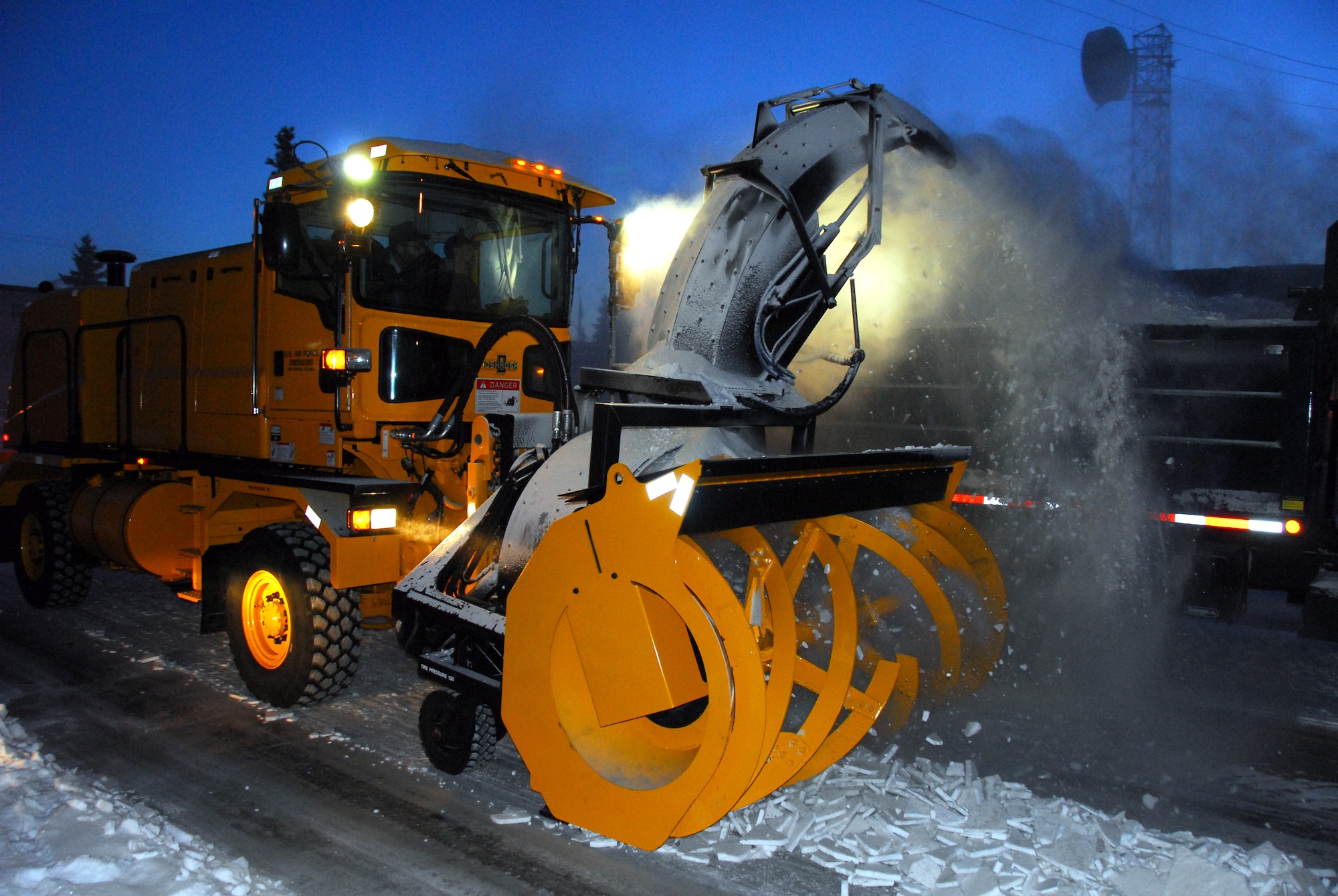 Airmen and civilian members with the 354th Civil Engineering Squadron Snow Barn clear snow from Wabash Street Nov. 3, 2009 on Eielson Air Force Base, Alaska. The snow barn members remove snow from 1.9 million square feet of airfield pavement and 105 miles of streets and parking lots on base to support mission operations. (U.S. Air Force photo/Tech. Sgt. Shad Eidson)