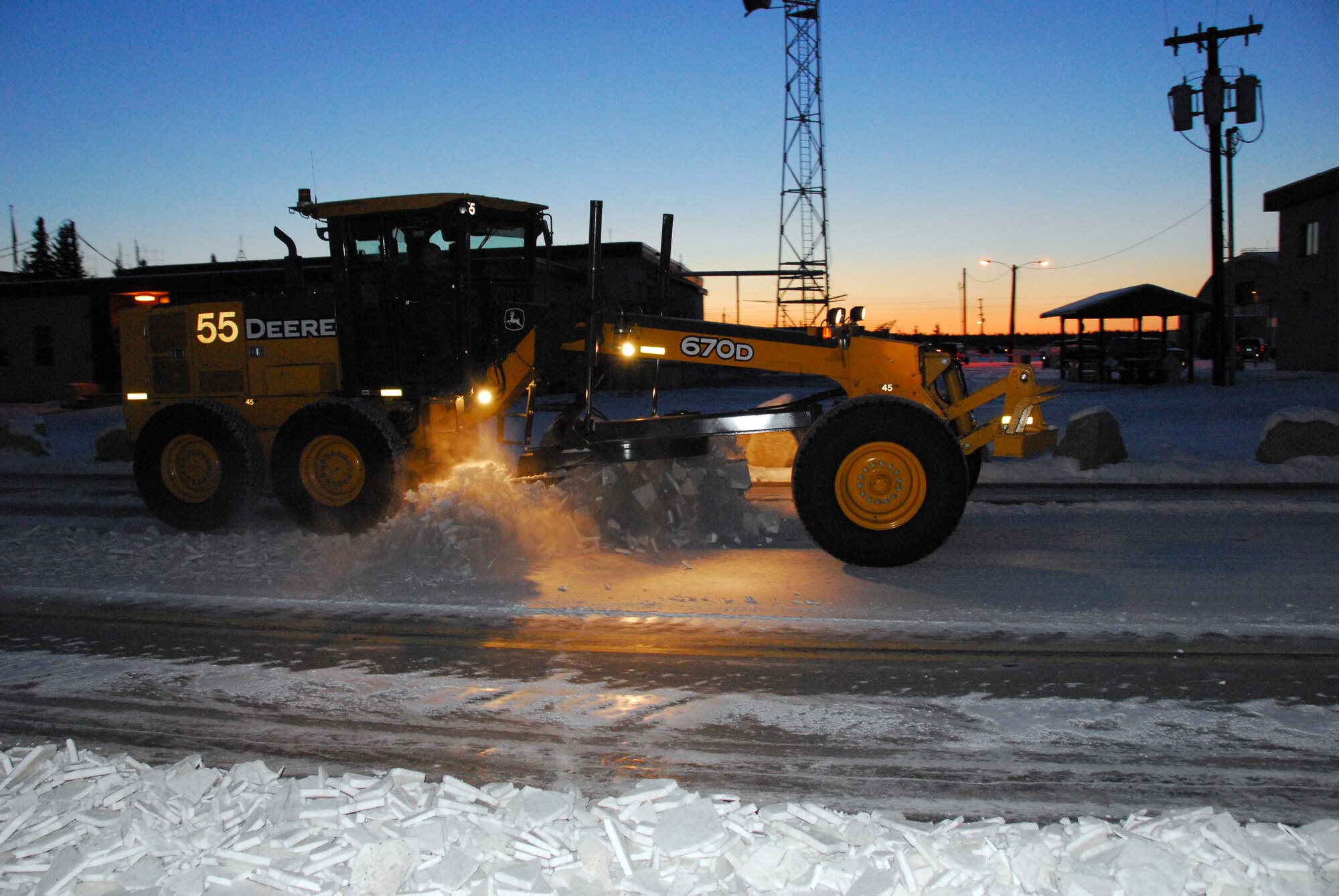 Airmen and civilian members with the 354th Civil Engineering Squadron Snow Barn clear Snow from Wabash Street Nov. 3, 2009 on Eielson Air Force Base, Alaska. The snow barn members remove snow from 1.9 million square feet of airfield pavement and 105 miles of streets and parking lots on base to support mission operations. (U.S. Air Force photo/Tech. Sgt. Shad Eidson)