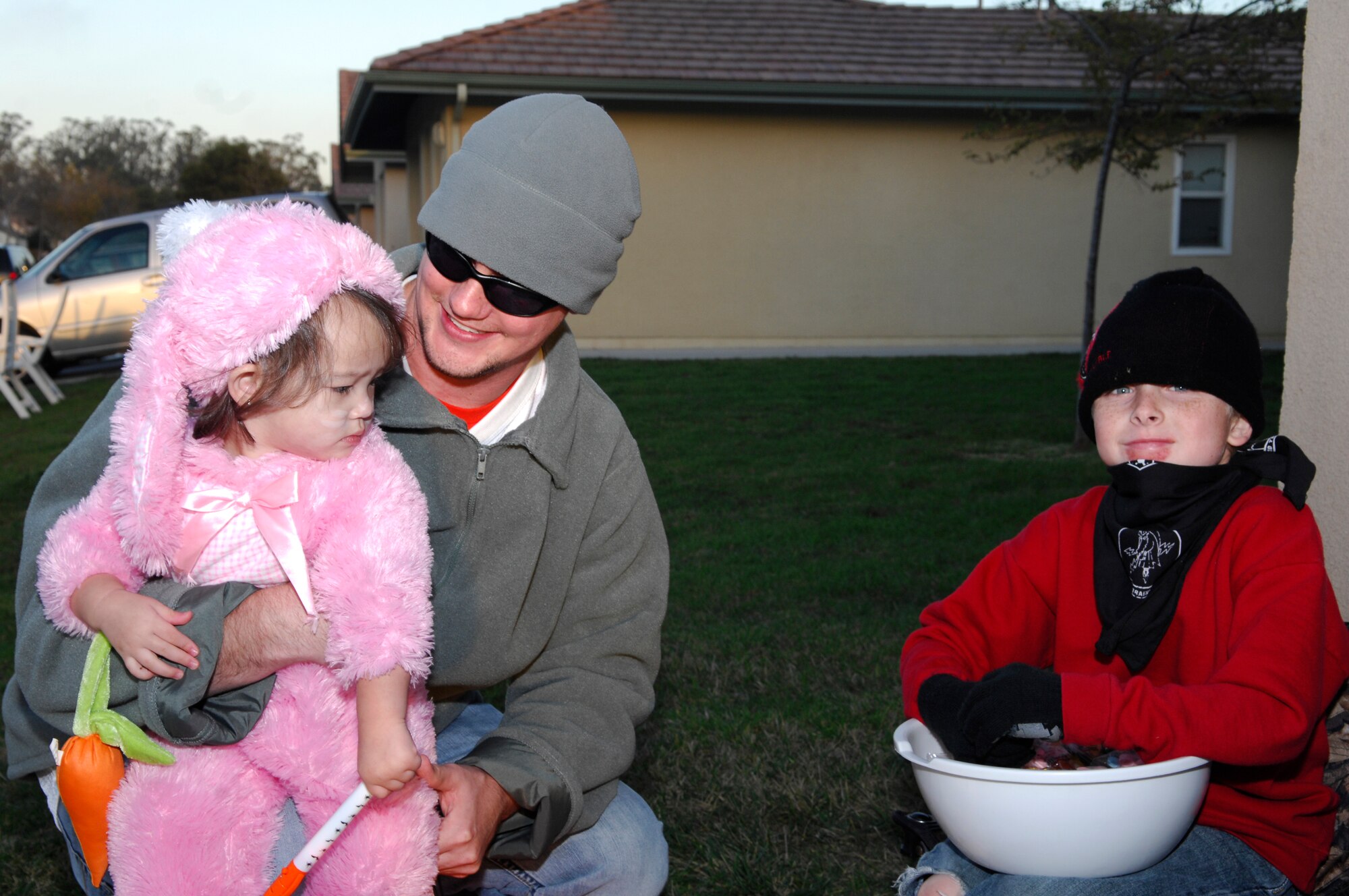 VANDENBERG AIR FORCE BASE, Calif. -- Trying to convince her not to be scared while trick or treating, Caleb Dymond, spouse of Staff Sgt.Janessa Dymond from the 30th Security Forces Sqaudron, holds daughter Chloe while Dustin Krambeck, son of Master Sgt. Dean Krambeck from the 576th Flight test Squadron attempts to hand her candy here Oct. 31, 2009. All dependent children at Vandenberg were invited to trick or treat while the streets were patrolled for safety. (U.S. Air Force photo/Airman 1st Class Heather R. Shaw)