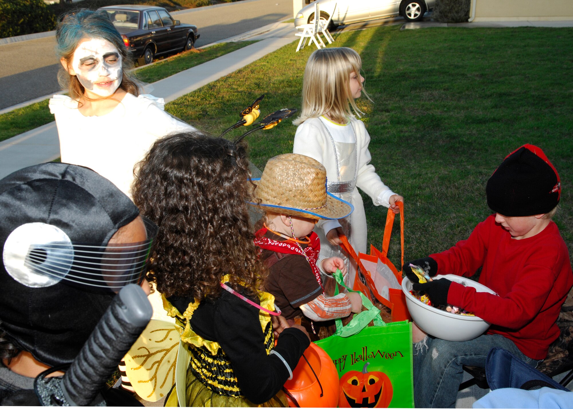 VANDENBERG AIR FORCE BASE, Calif. -- Awaiting their turn at the candy bowl, a group of children show off their Halloween costumes and ready their candy bags at an on-base  house while trick or treating here Saturday, Oct. 31, 2009. Members of the 30th Security Forces Squadron patrolled the streets in an effort to makes sure all the children were safe. (U.S. Air Force photo/Airman 1st Class Heather R. Shaw)