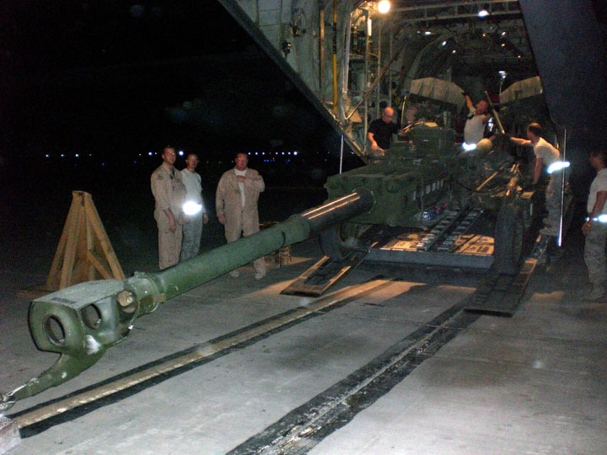Deployed Airmen from the 139th Airlift Wing load a howitzer at a forward operating location.  (Submitted photograph)