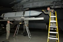 MINOT AIR FORCE BASE, N.D. -- Senior Airman Lewis Swartz calls out commands to Senior Airman Joshua Nix, both members of the 5th Aircraft Maintenance Squadron weapons load crew, to line up an AGM-158 joint air to surface standoff missile during a load crew competition here, Oct. 30. Each load crew team consists of four Airmen who are evaluated every month on how well they load different types of weapons. (U.S. Air Force photo by Senior Airman Matthew Smith)