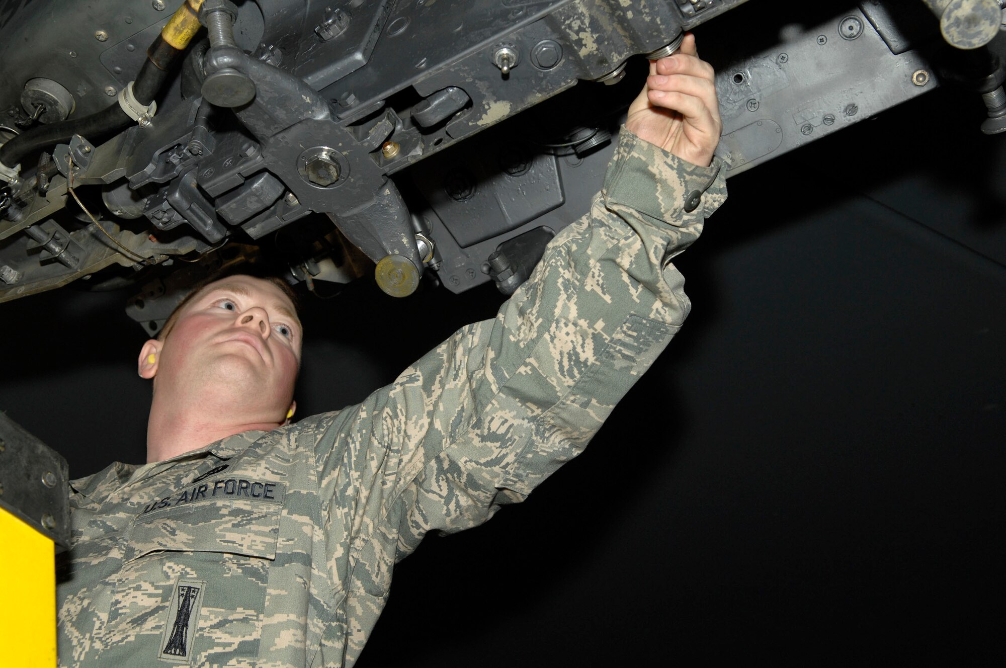 MINOT AIR FORCE BASE, N.D. – Senior Airman Lewis Swartz, 5th Aircraft Maintenance Squadron weapons load crew member, performs a bomb rack preparation on a B-52H Stratofortress during a load crew competition here, Oct. 30. Each load crew team consists of four Airmen who are evaluated every month on how well they load different types of weapons. (U.S. Air Force photo by Senior Airman Matthew Smith)
