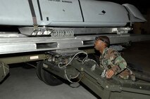 MINOT AIR FORCE BASE, N.D. -- Senior Airman Devonde Reuben, 5th Aircraft Maintenance Squadron weapons load crew member, positions the boom of a MHU-83 lift truck to lift an AGM-158 joint air to surface standoff missile during a load crew competition here, Oct. 30. Each load crew team consists of four Airmen who are evaluated every month on how well they load different types of weapons. (U.S. Air Force photo by Senior Airman Matthew Smith)